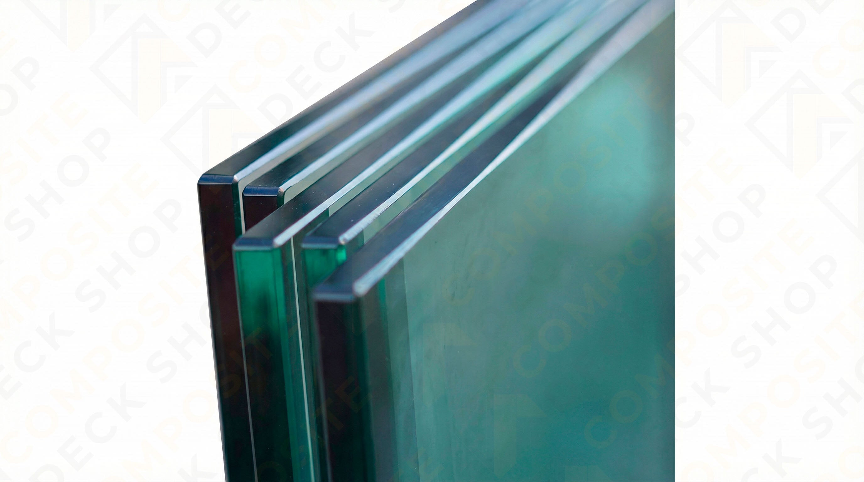 Close-up of stacked, thick tempered glass panels with green-tinted edges—ideal for frameless glass railing projects.
