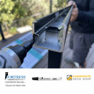A person uses a power tool to assemble a metal railing; Fortress Railing and railing touch up tools featured.